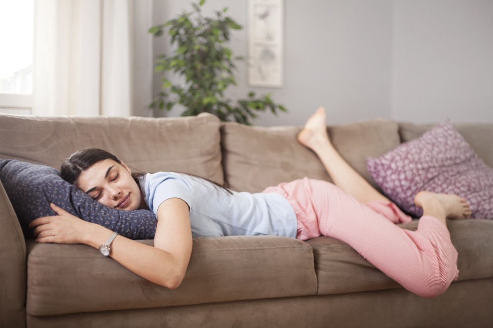 a woman laying on couch and resting