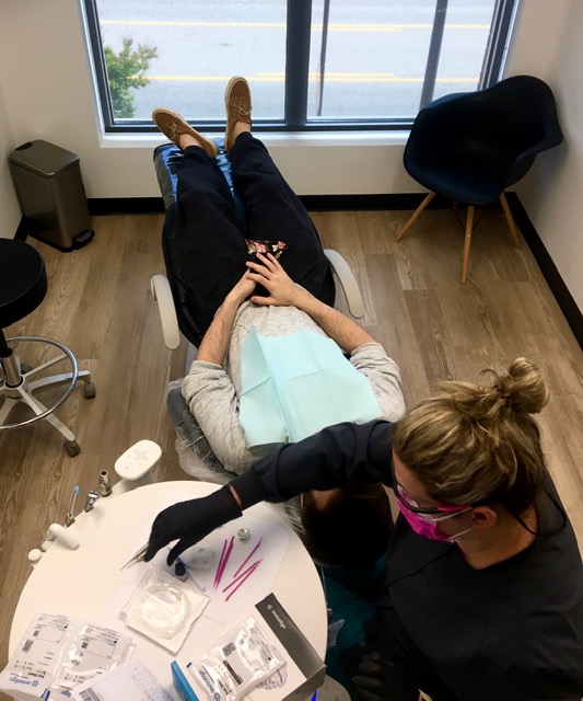 woman patient smiling up at dentist