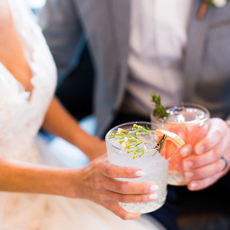 Wedding couple toasting glasses of coktails at wedding breakfast reception in Bournemouth
