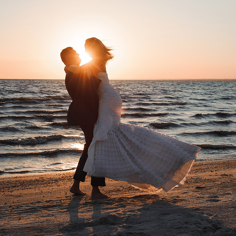 Wedding couple on beach in sunset