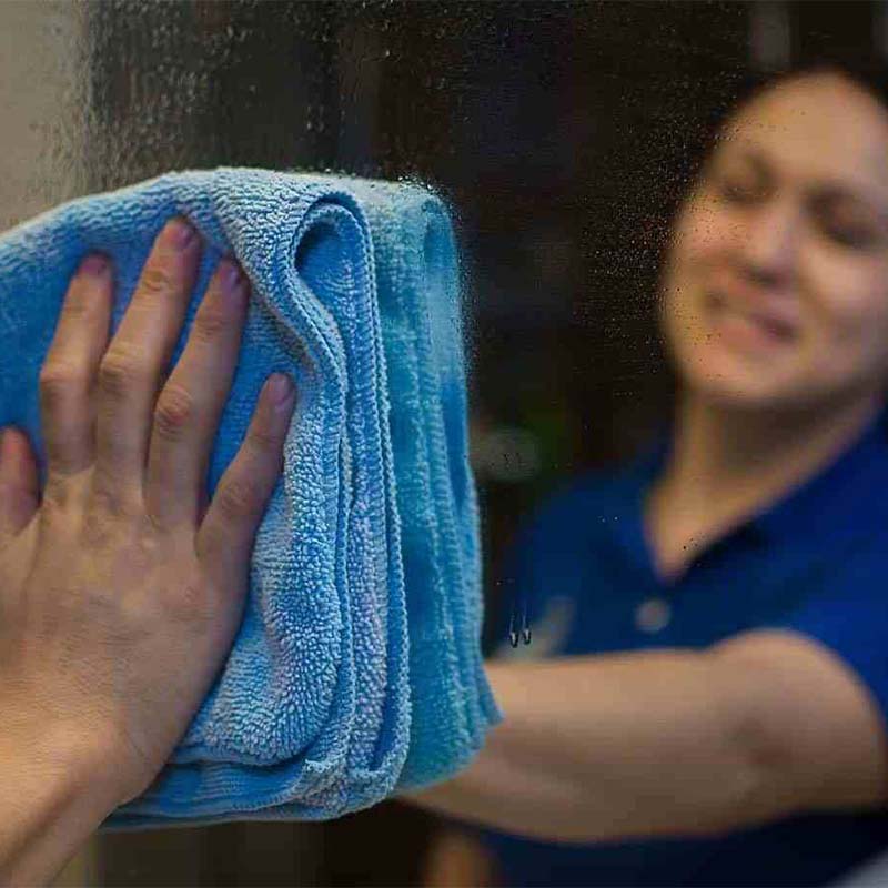 Bee Maids technician cleaning mirror