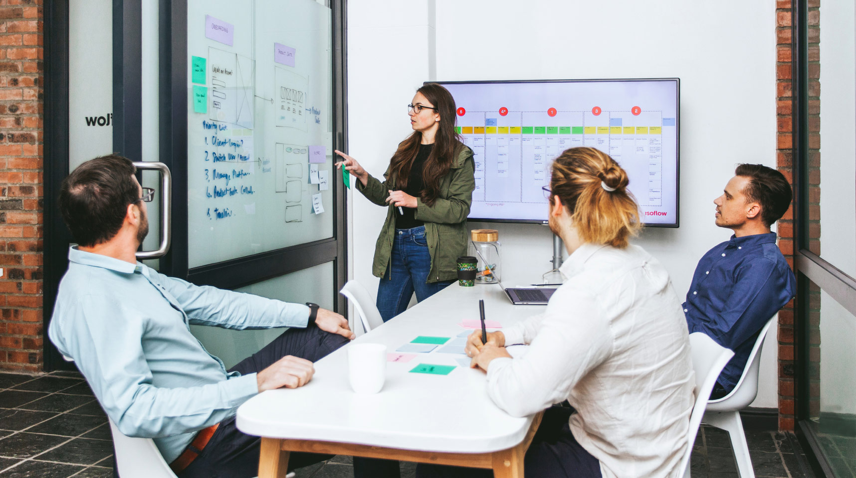 Team members Werner, Ruth, Byron and Renier discussing UX wireframes in our small boardroom.