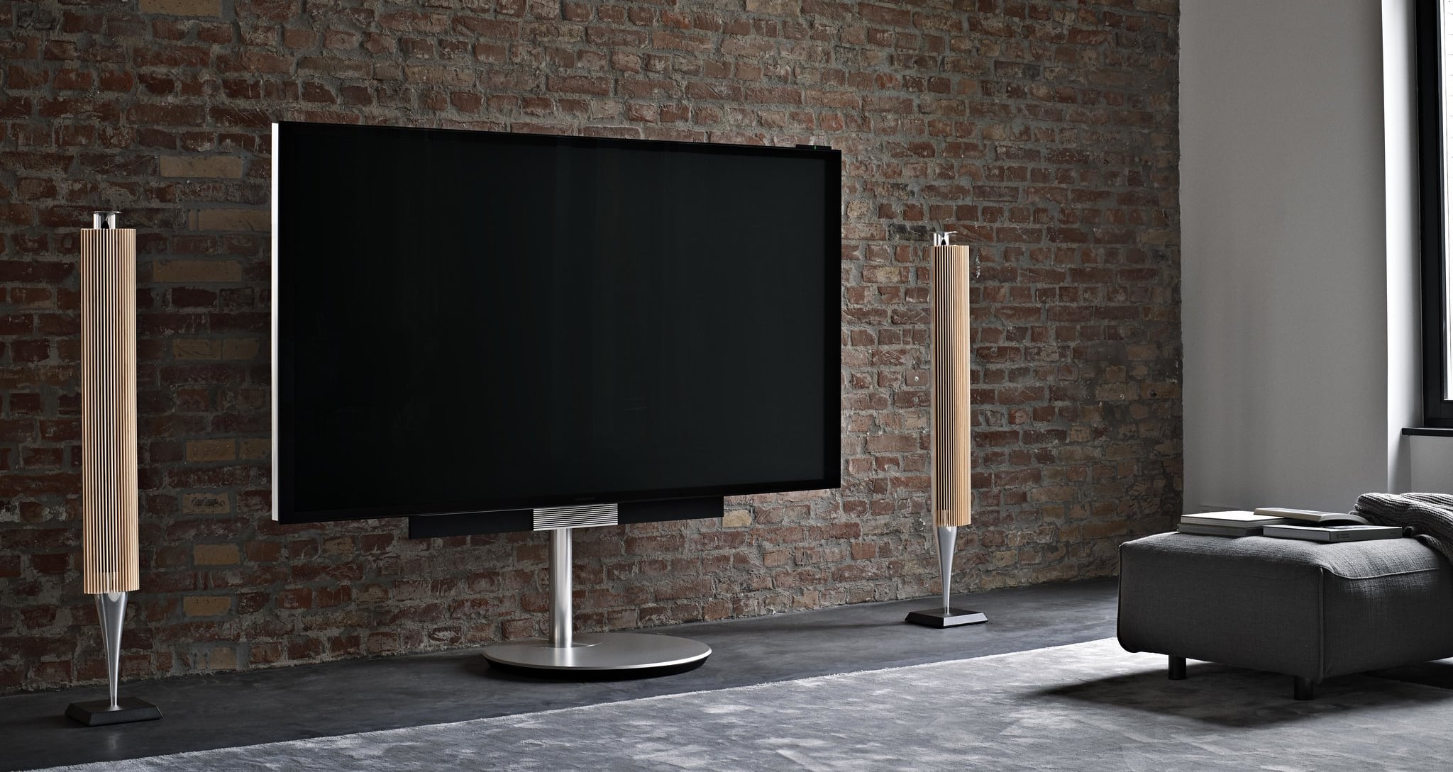 A media room with a TV and speakers