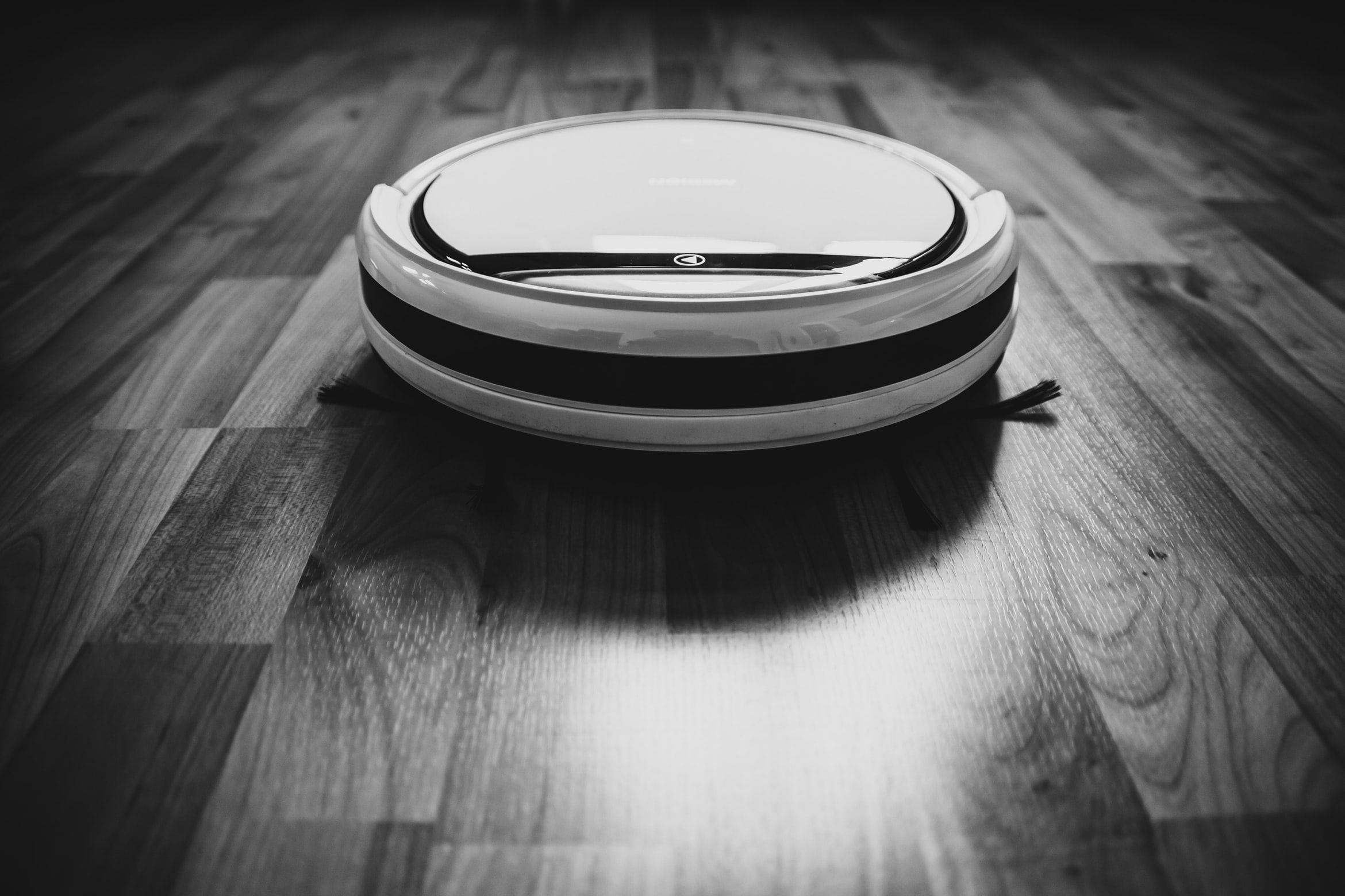 a robotic vacuum cleaner cleaning hard floors