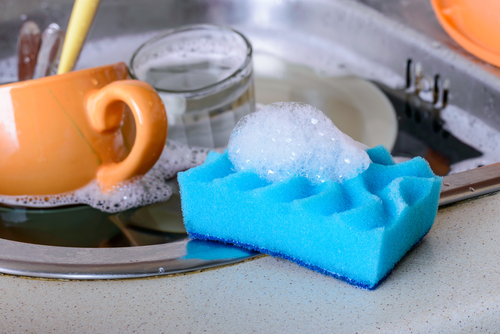 A dirty sponge in an office kitchen