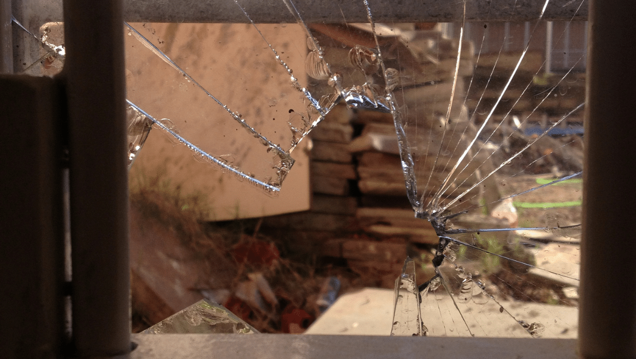 A broken window with jagged glass