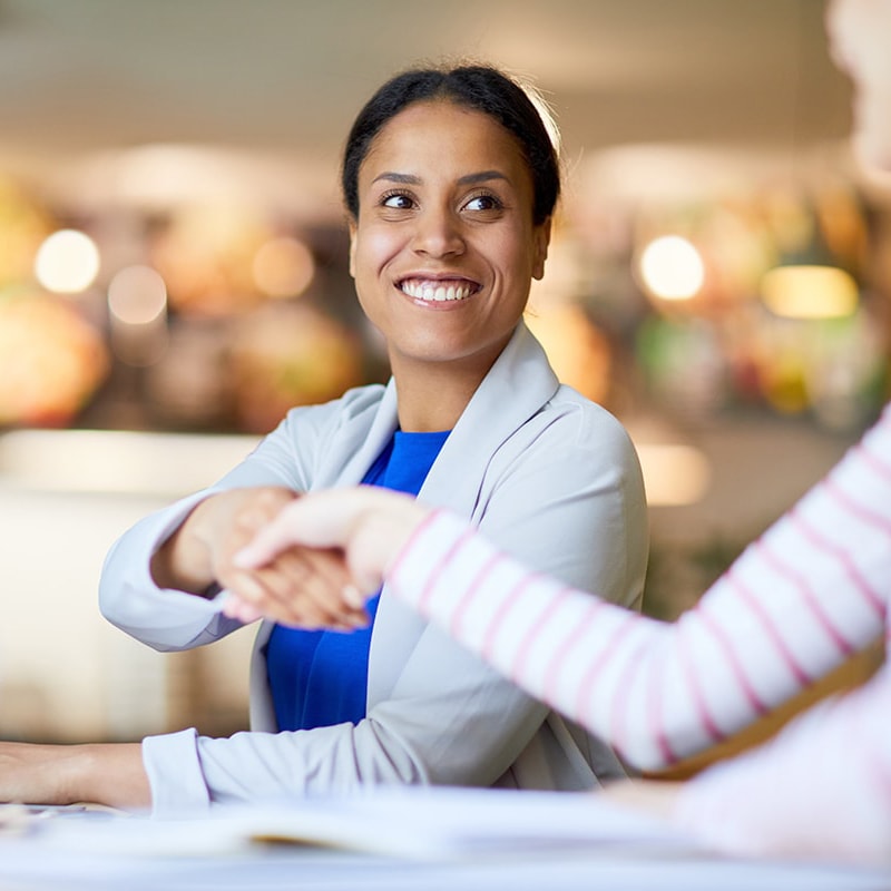 Two women shaking hands