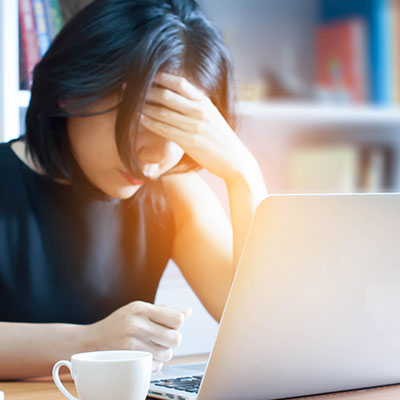 Stressed woman at laptop