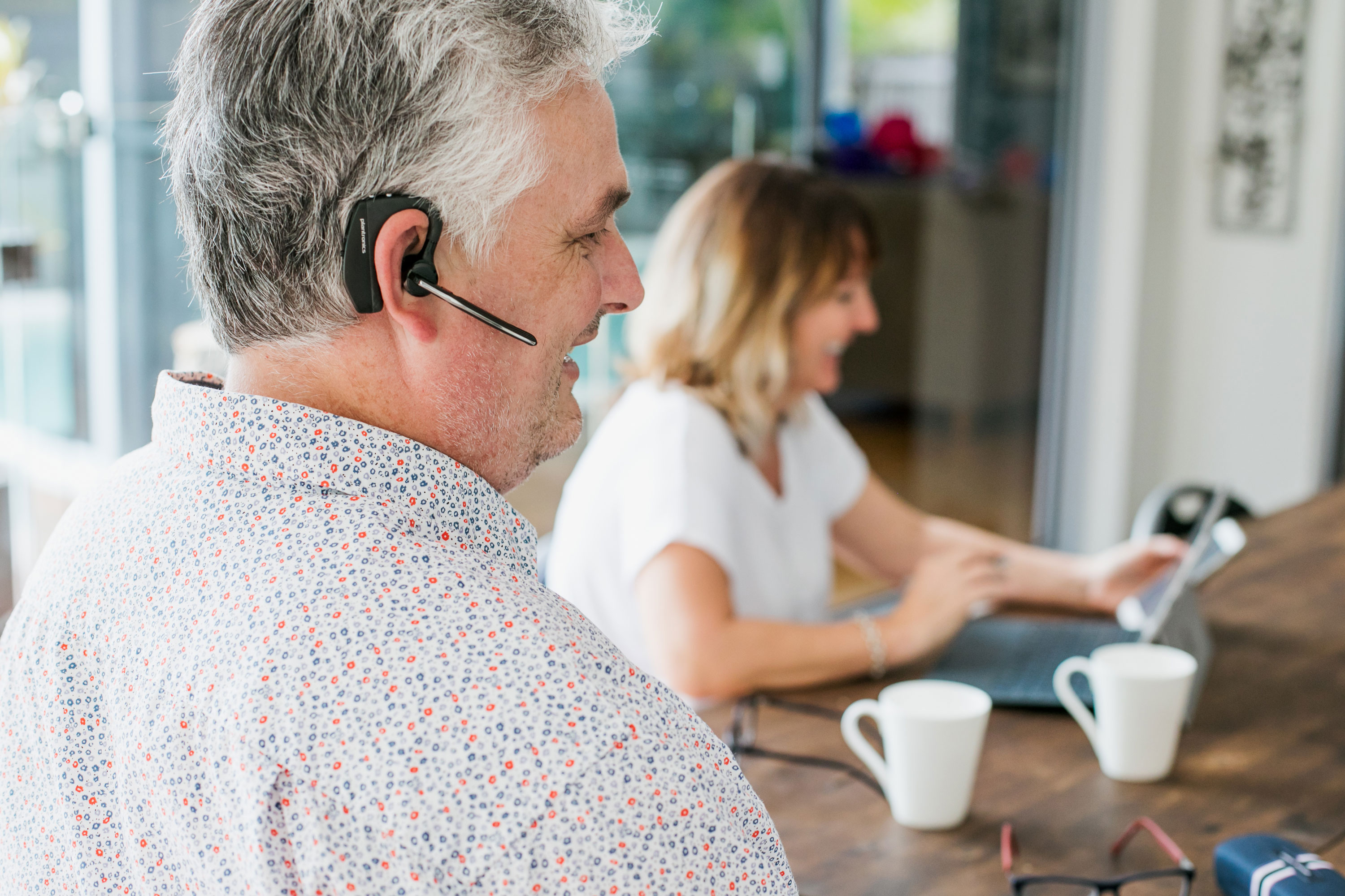 Man wearing in-ear assistive technology