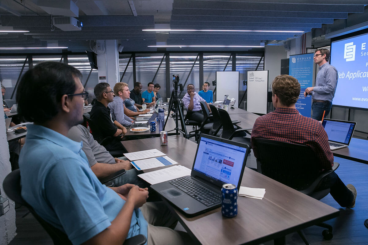 adult students in a modern classroom during a cybersecurity training class