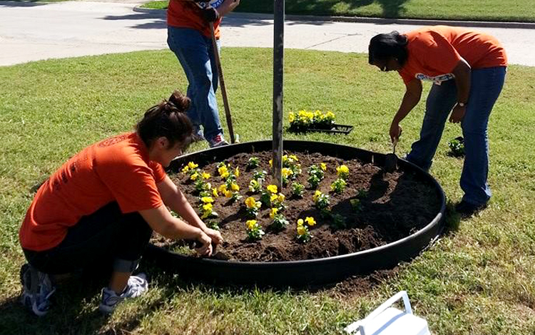 Volunteers planting flowers at The Journey Home
