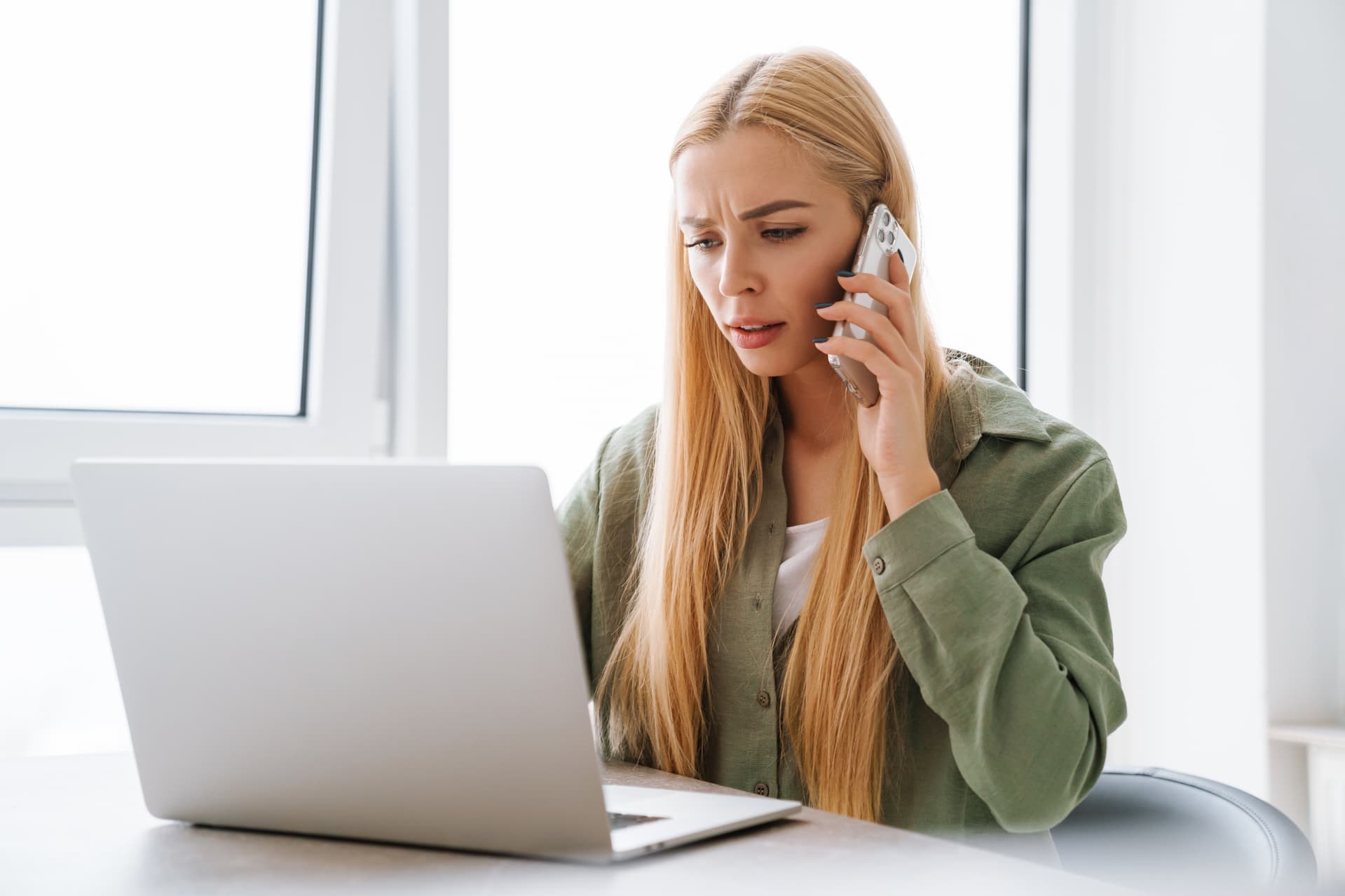 Woman with a confused expression used a laptop computer