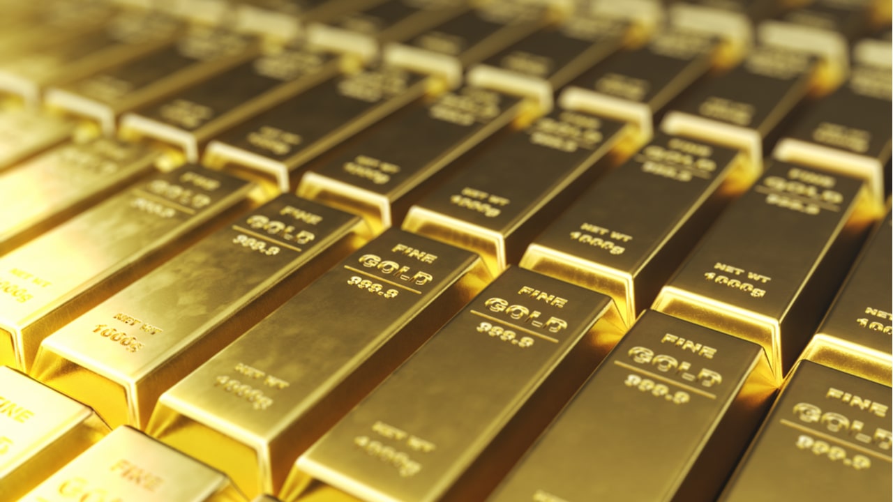 Diversas barras de ouro alinhadas, com os dizeres Fine Gold 999.9