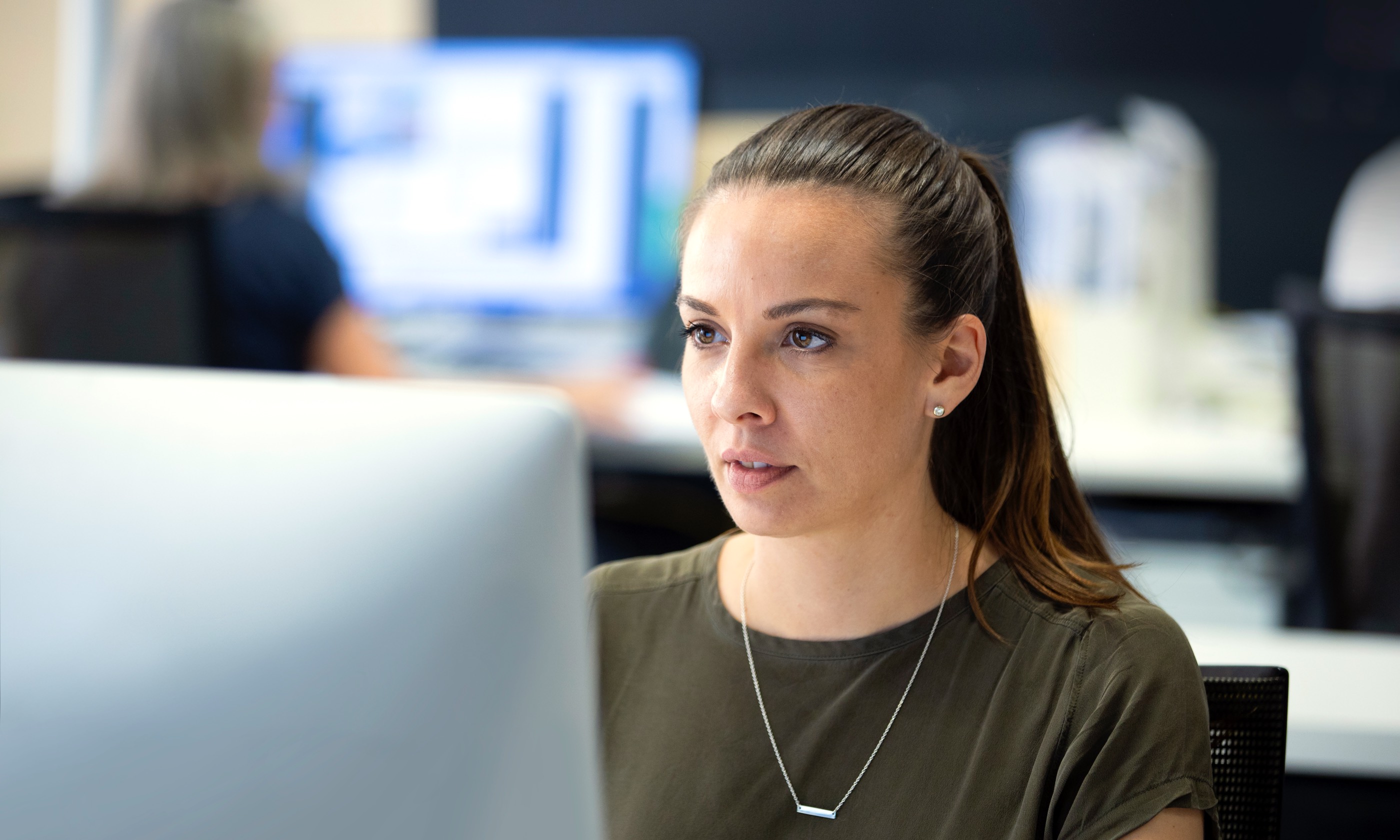 Designate team member working in studio at computer.