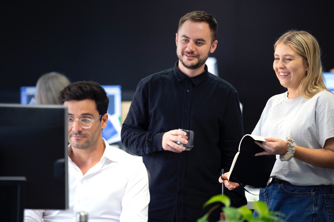 Designate team members in studio discussing brand strategy.