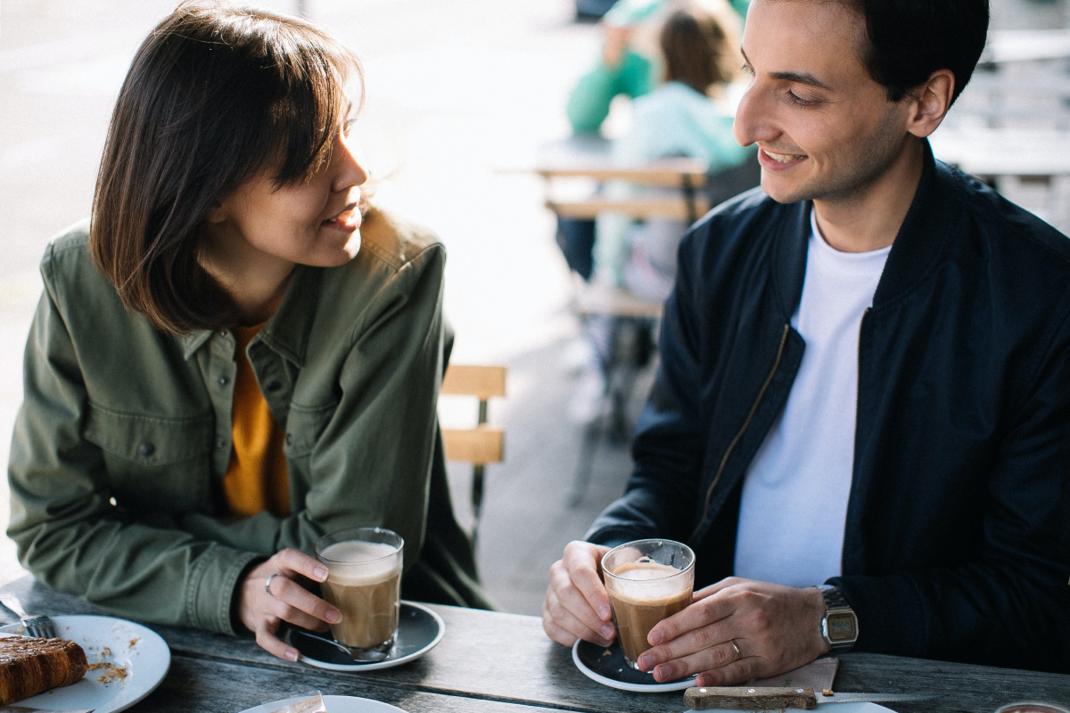 Two friends drinking coffee talking about epilepsy and caffeine