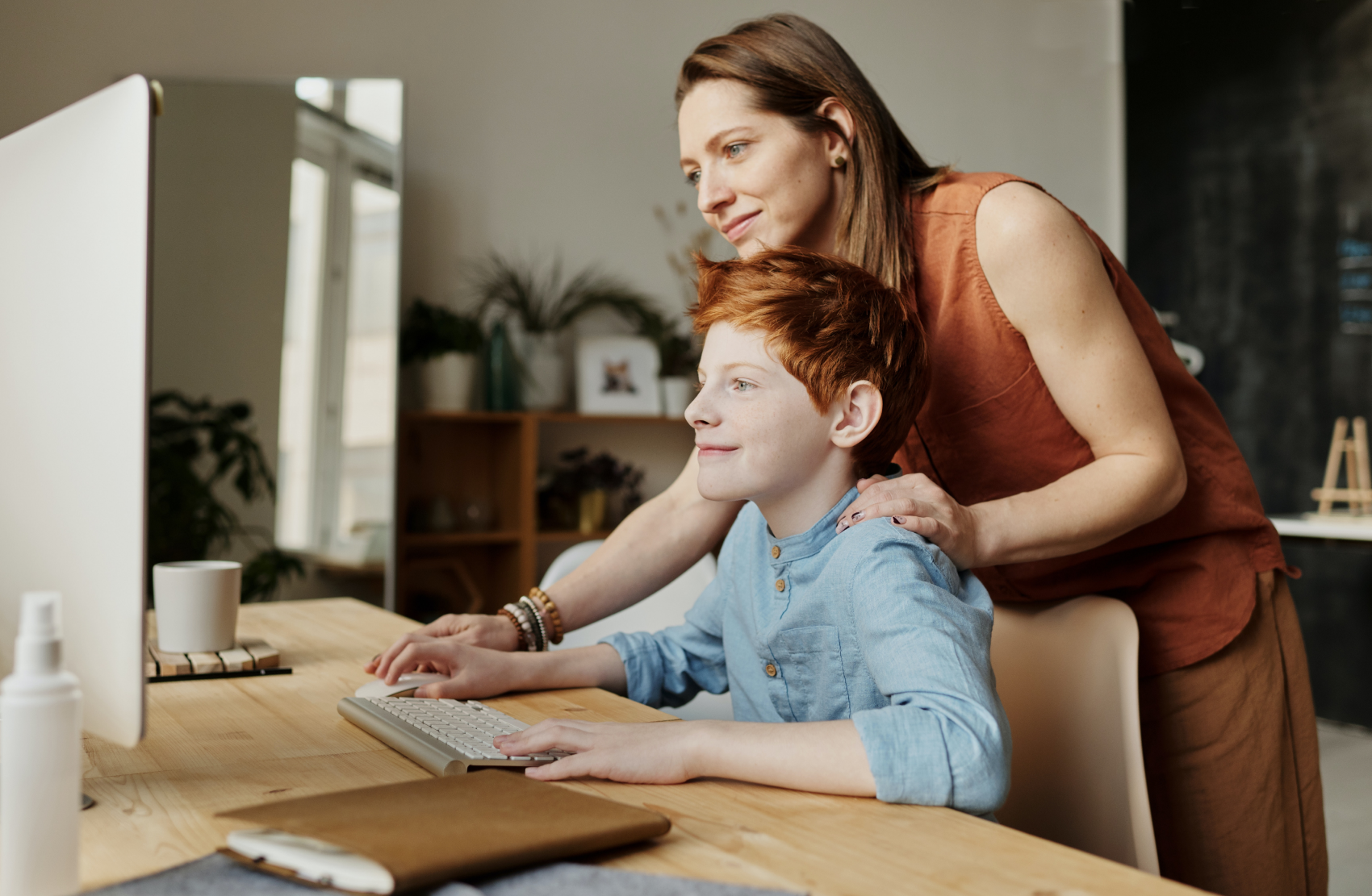 Mother and son learning what causes epilepsy in children together on a computer
