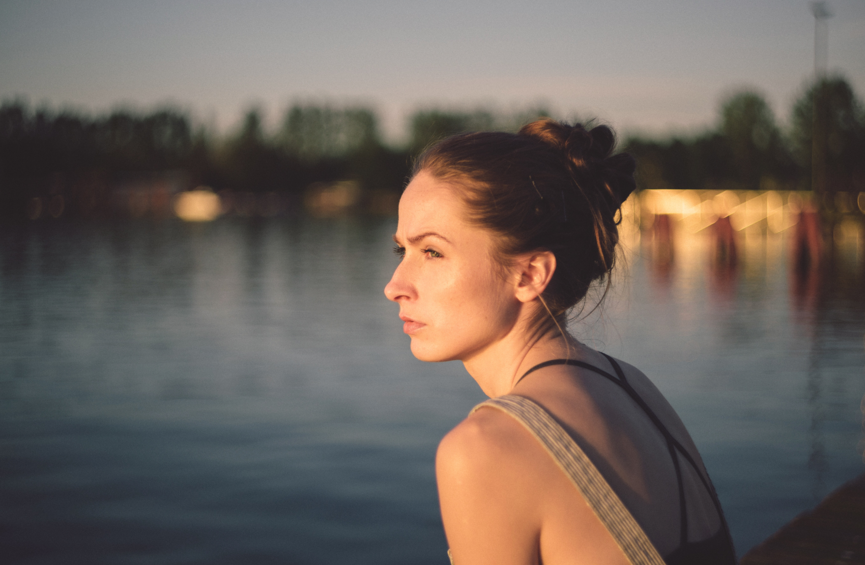 Woman sits by river with epilepsy and depression