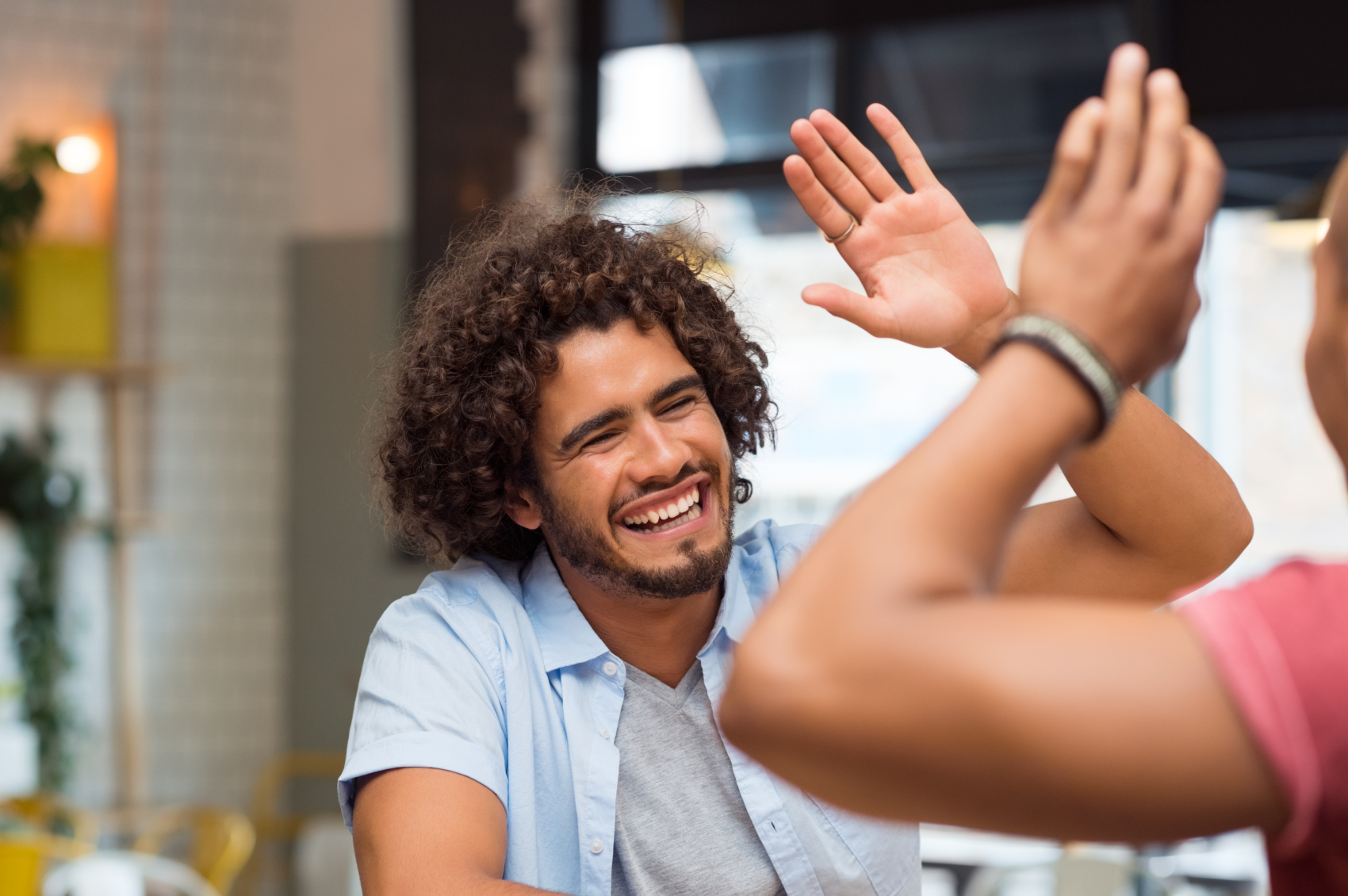 Smiling friends high fiving