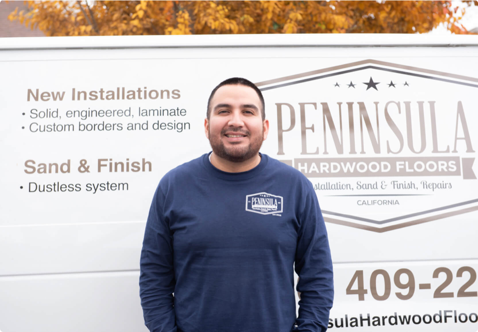 Hourly customer Juan Arias of Peninsula Hardwood Floors in front of their van