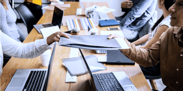 team working on a table with computers