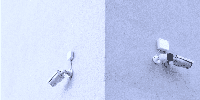 two secutity cameras on a wall