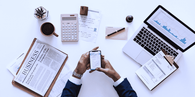 executive using mobile phone in an office desk