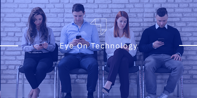 four people sitting and using mobile phones