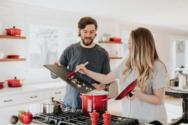 man and woman cooking in the kitchen