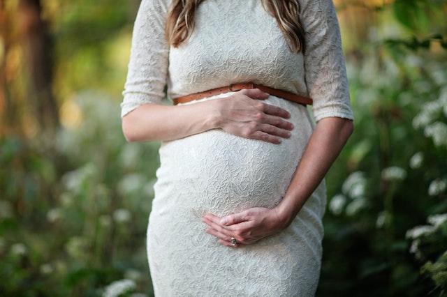 pregnant woman holding belly
