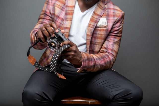 man in nice suit holding camera