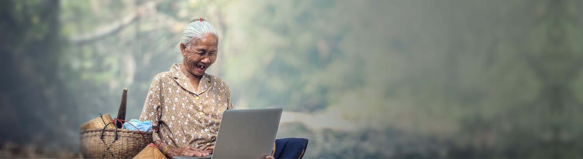 old lady smiling looking at computer