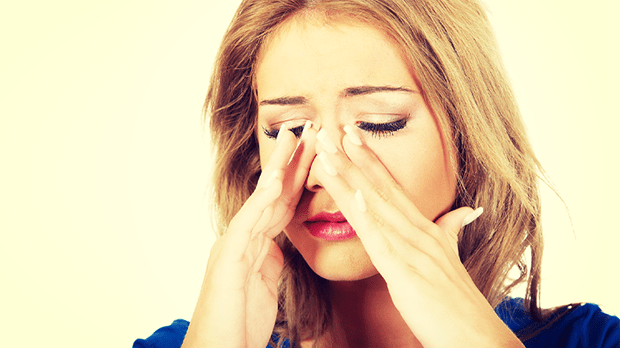 Woman suffering with nasal congestion due to polyps