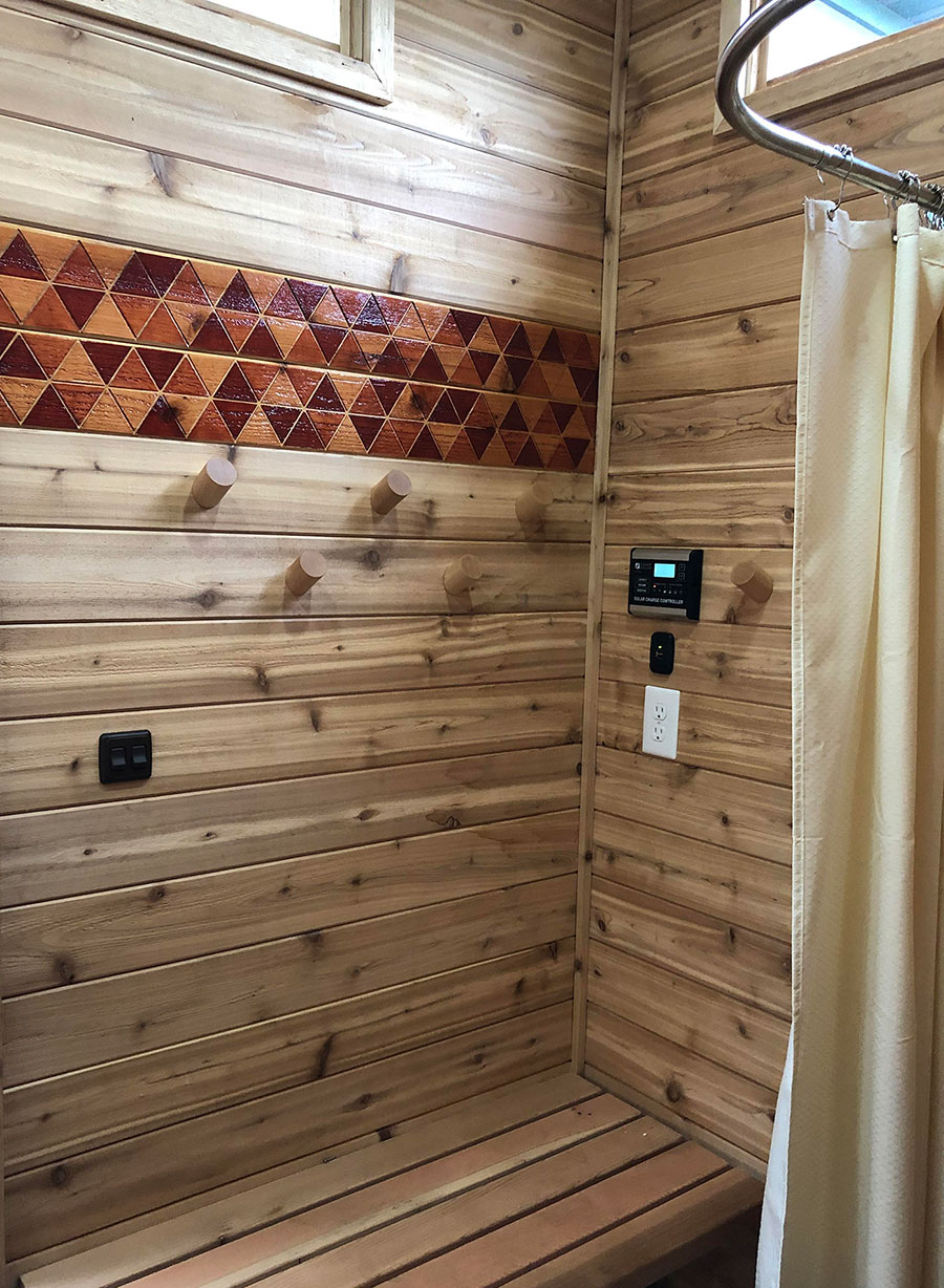 Shower area within a backyard sauna