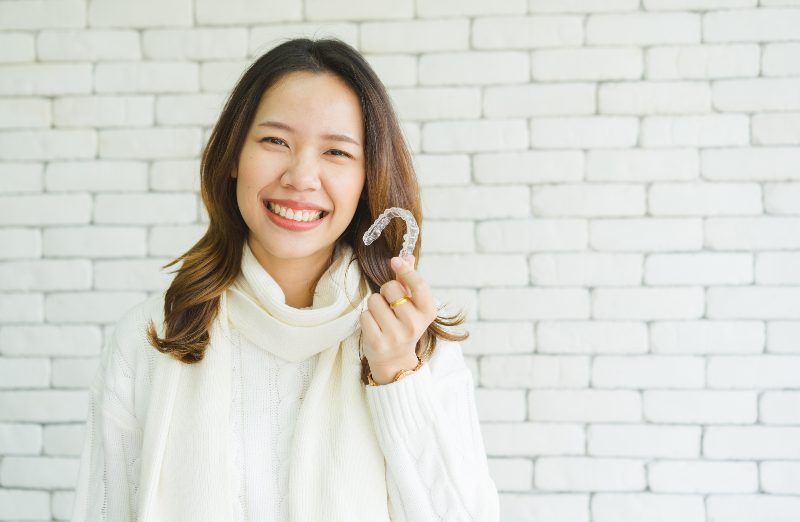 woman smiling with invsialign