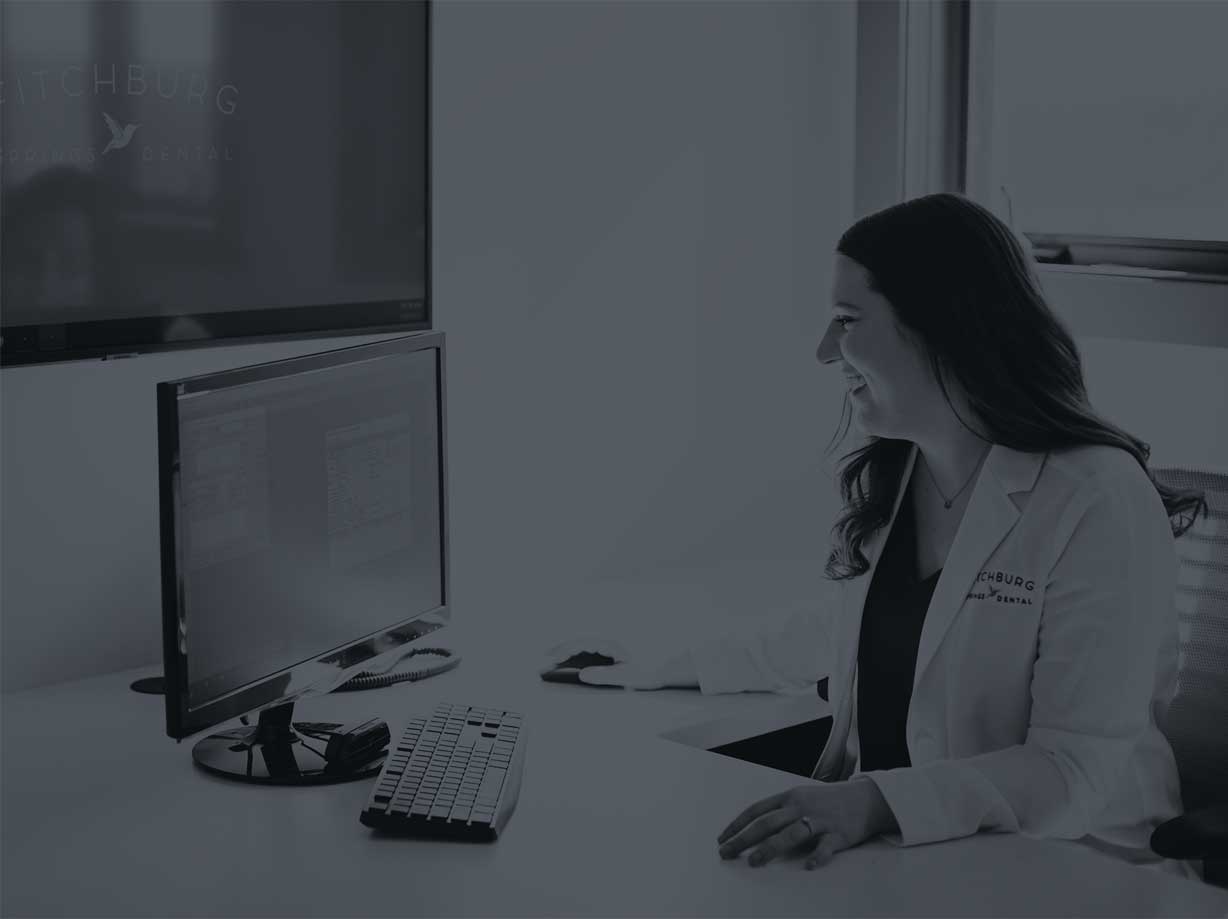 Photo of a dentist using a computer