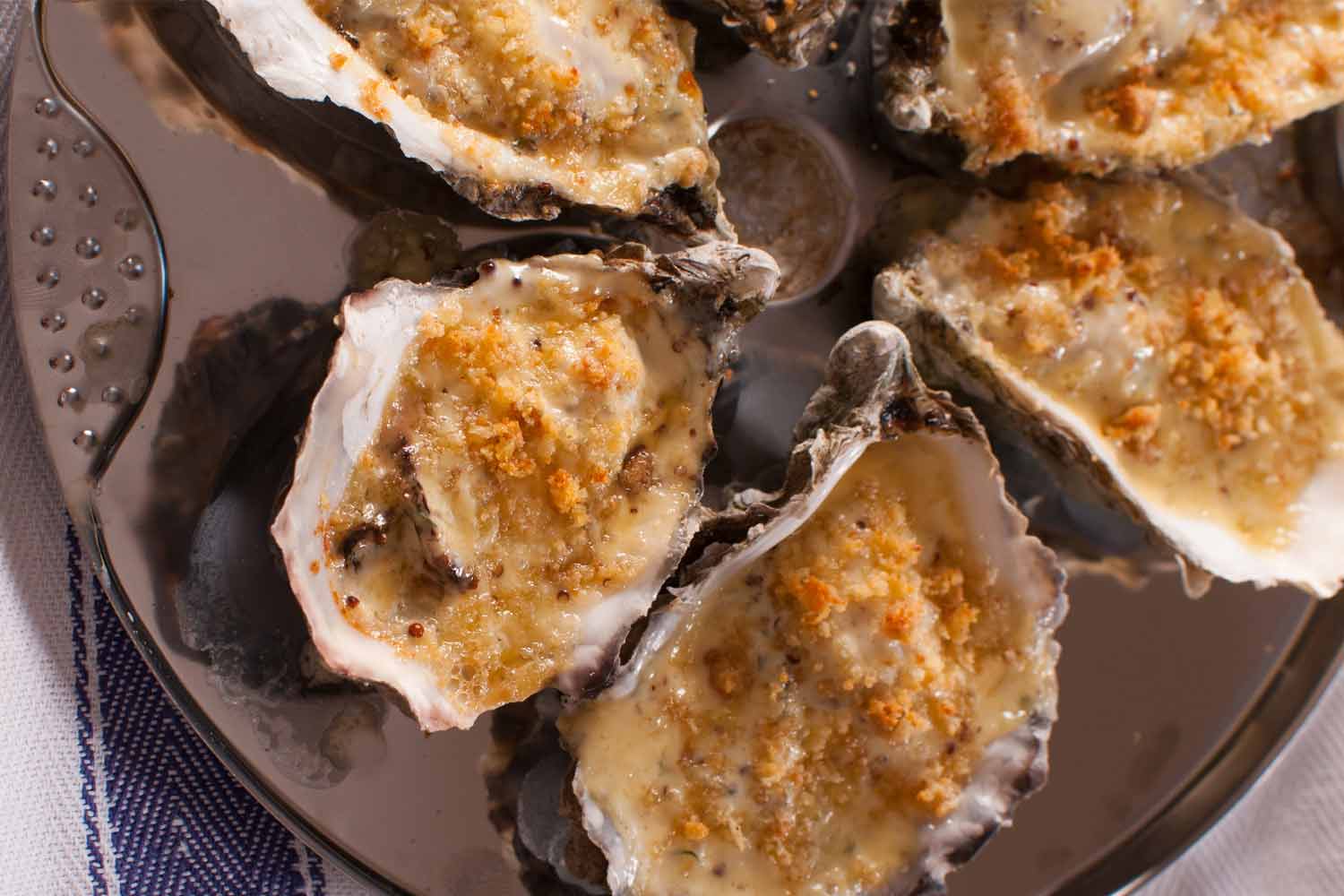 Oysters Kilpatrick with bacon, white wine cream sauce and herb breadcrumbs