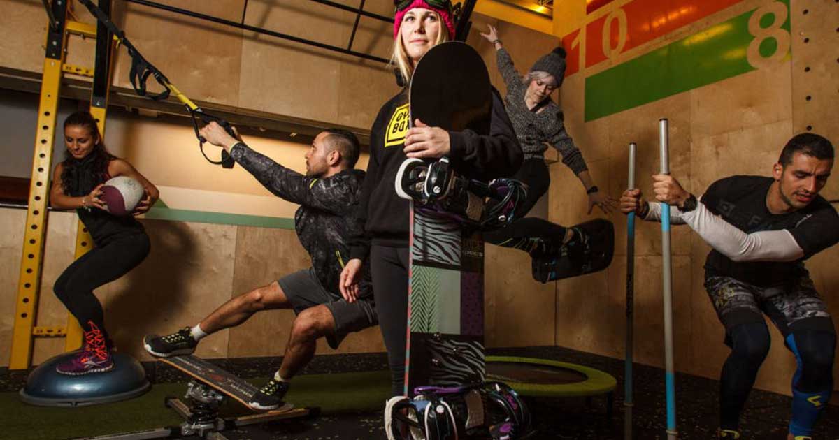 people in the gym in snowboard equipment