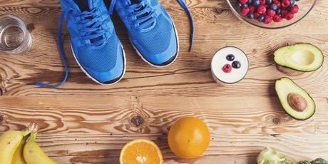 food on a wooden board and some blue trainers