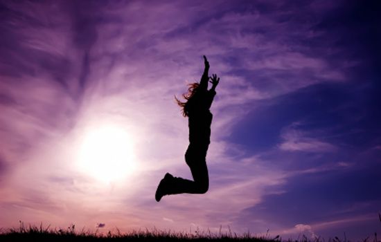 a woman jumping for joy in the air