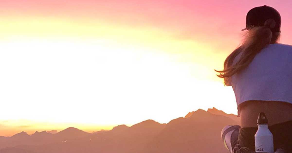 Women meditating viewing sunrise