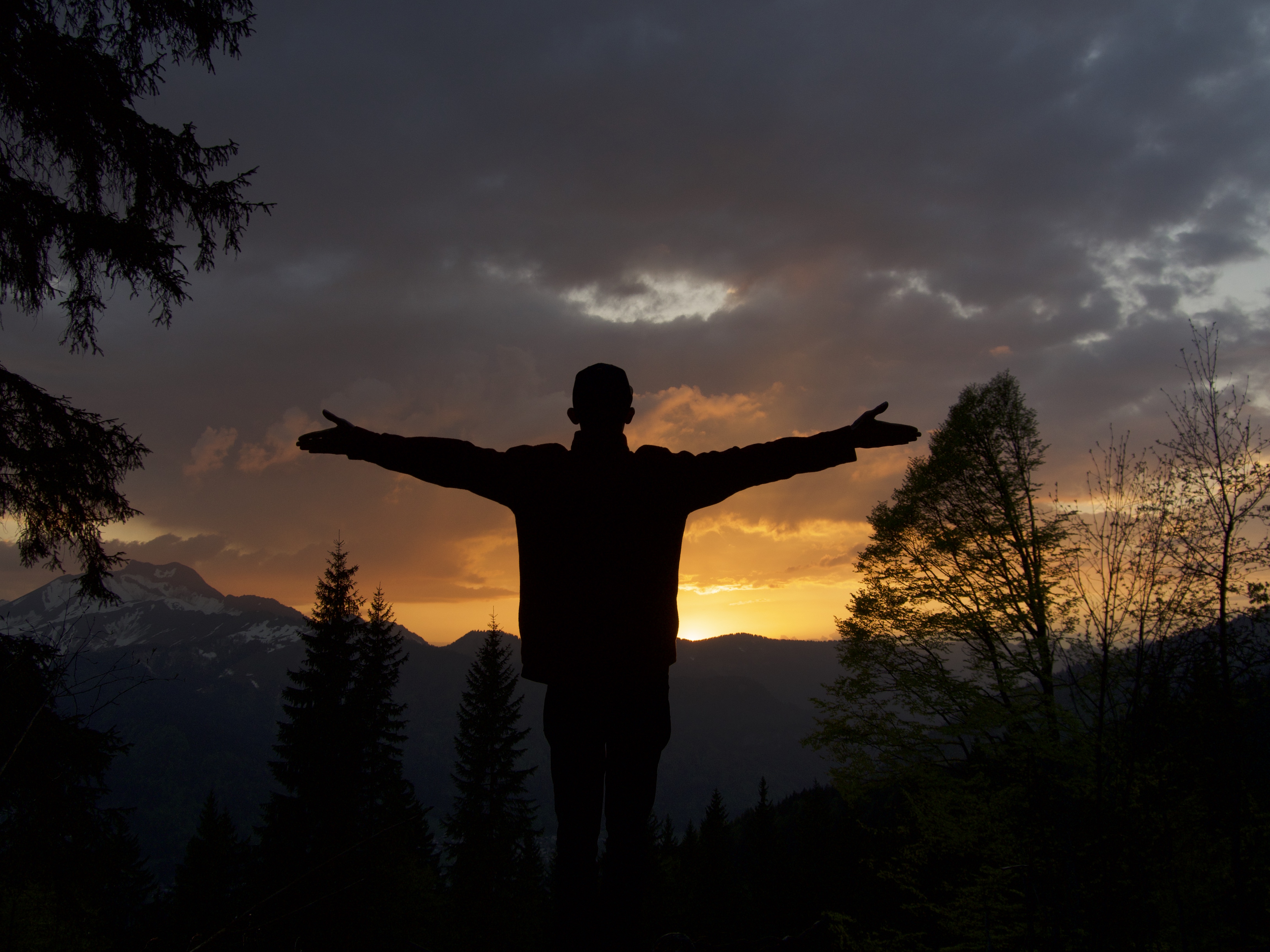 Man at top of mountain at Sunset Fit for Living