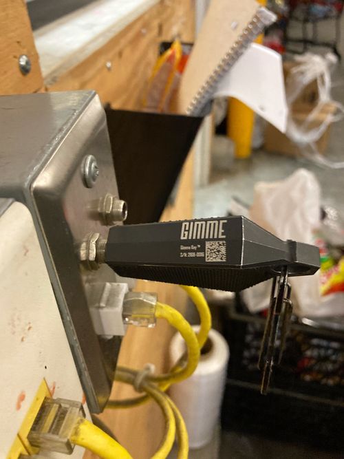 A Combat BLACK Gimme Key Pro wireless Bluetooth (BLE) DEX adapter plugged in to the receiving dock computer on a direct store delivery (DSD) route.