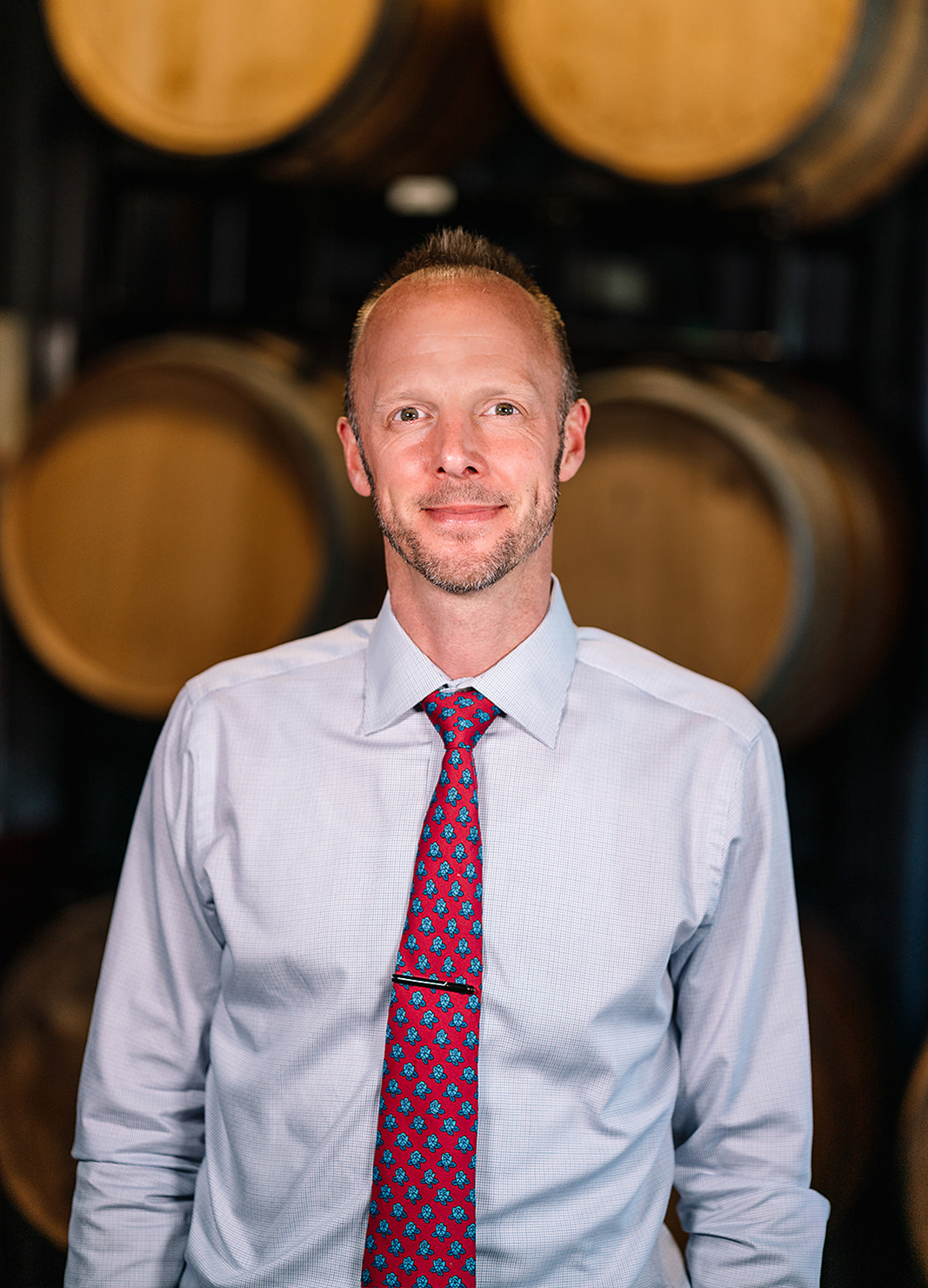 Carboy Wine Operations Director, Jason Snopkoski, standing in front of wine barrels