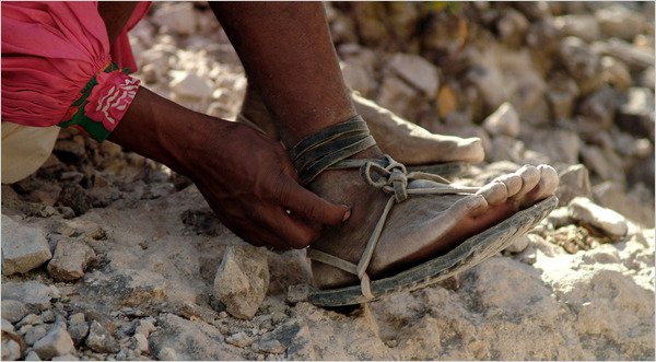 BASIC FOOTWEAR Arnulfo Quimare, a Tarahumara Indian who is a champion distance runner, laces up his sandals for a 50-mile race on canyon trails. Credit Luis Escobar