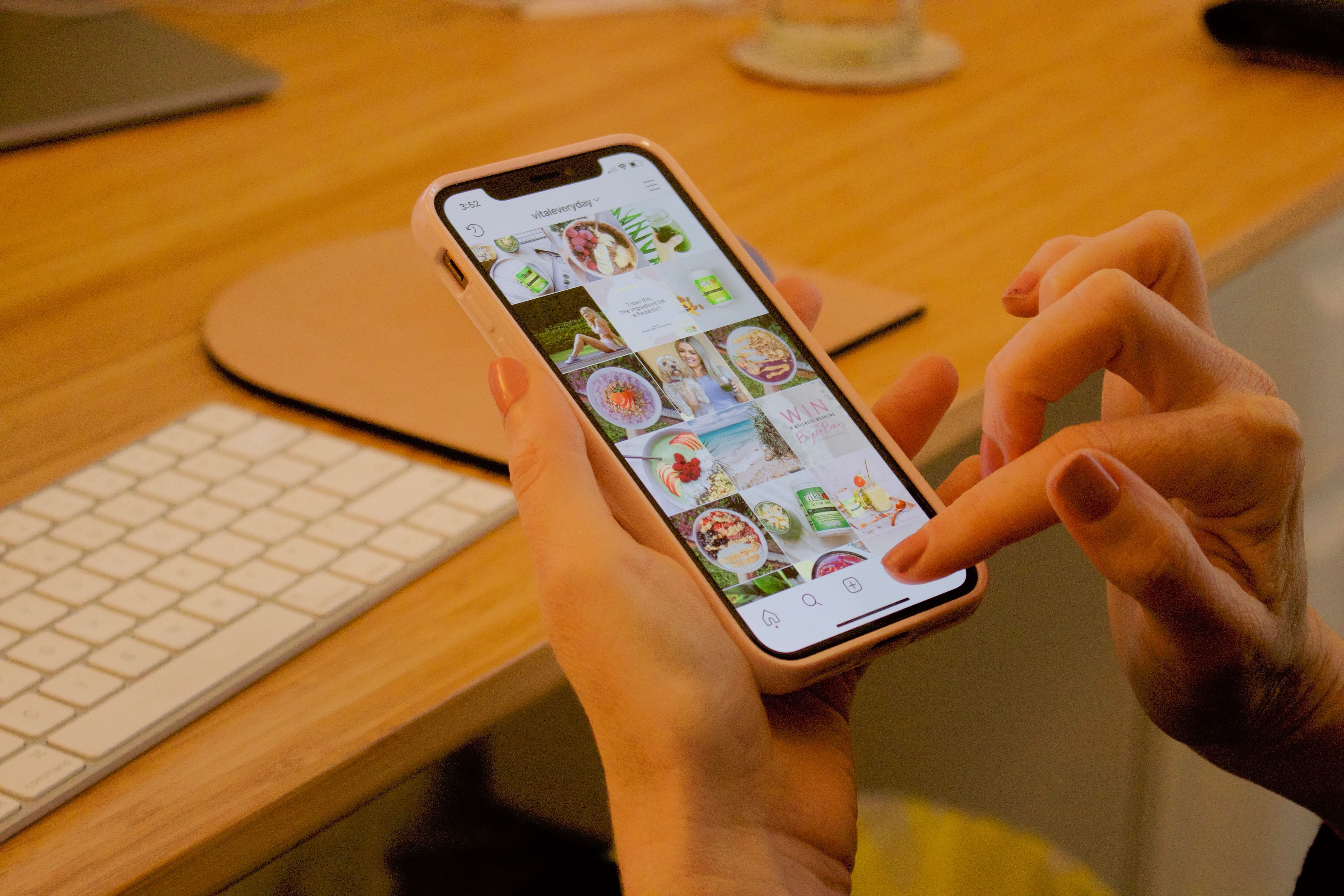 hand holding phone showing Instagram account