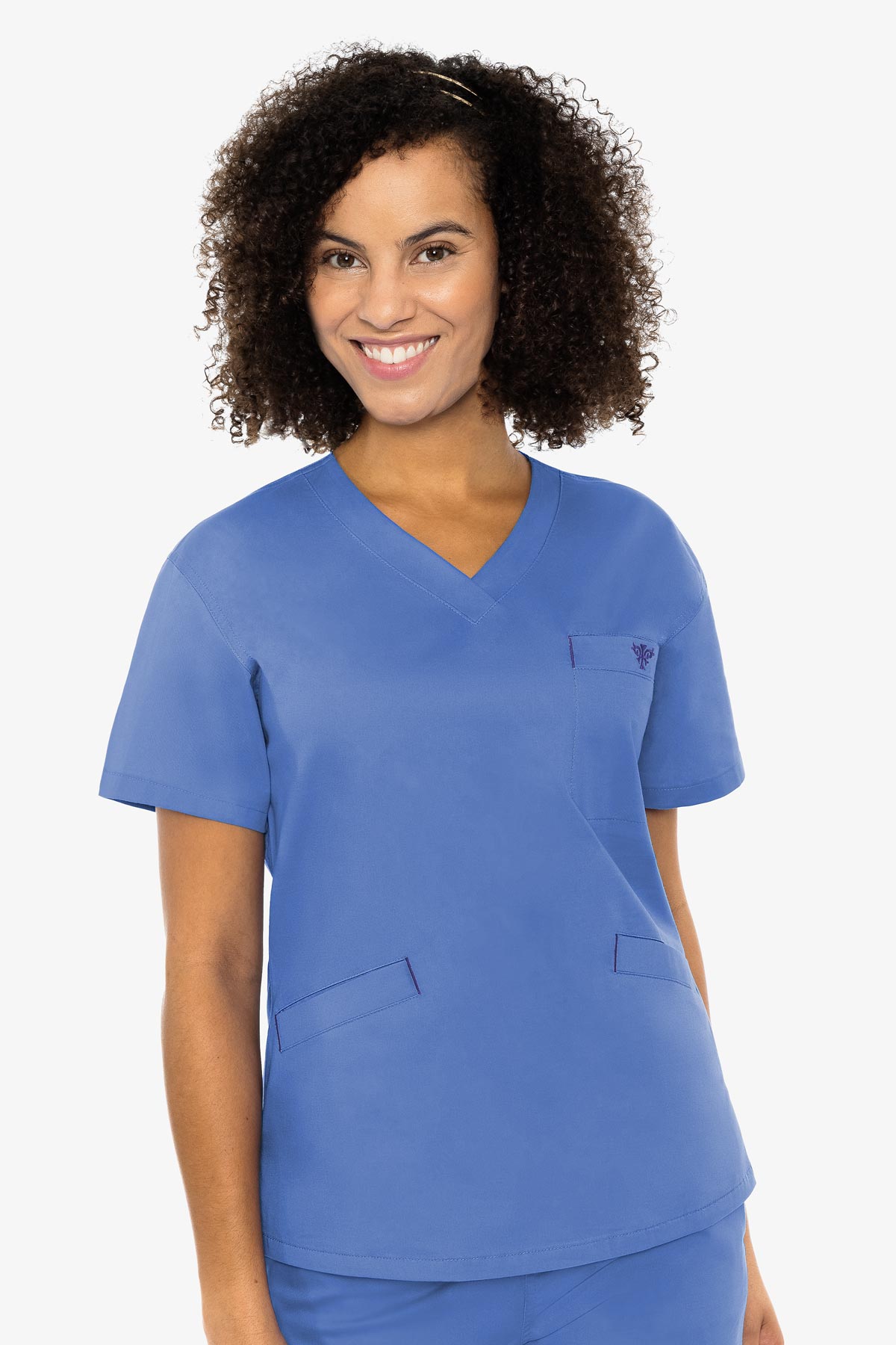 N. Classics never go out of style. This fun scrub top is a simple, yet has a flattering silhouette, welt pockets, and a contrast back neck panel.