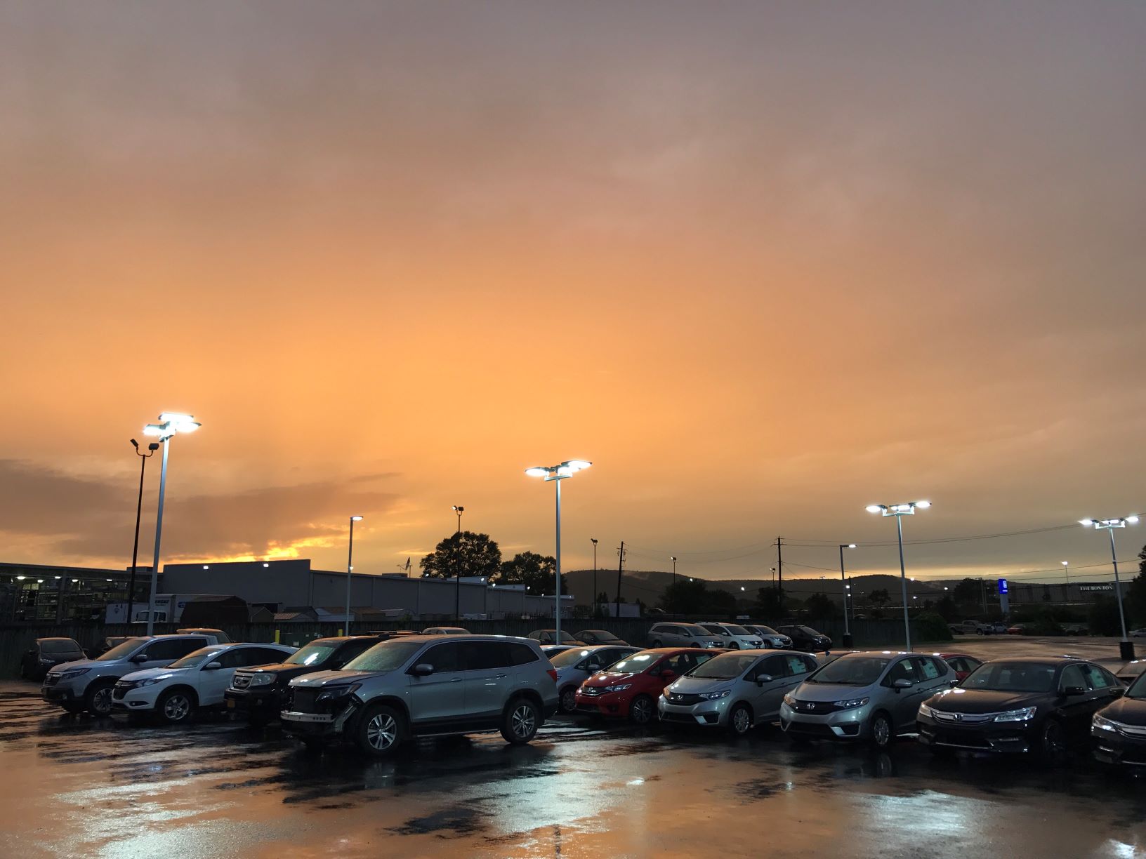 car dealership at sunset