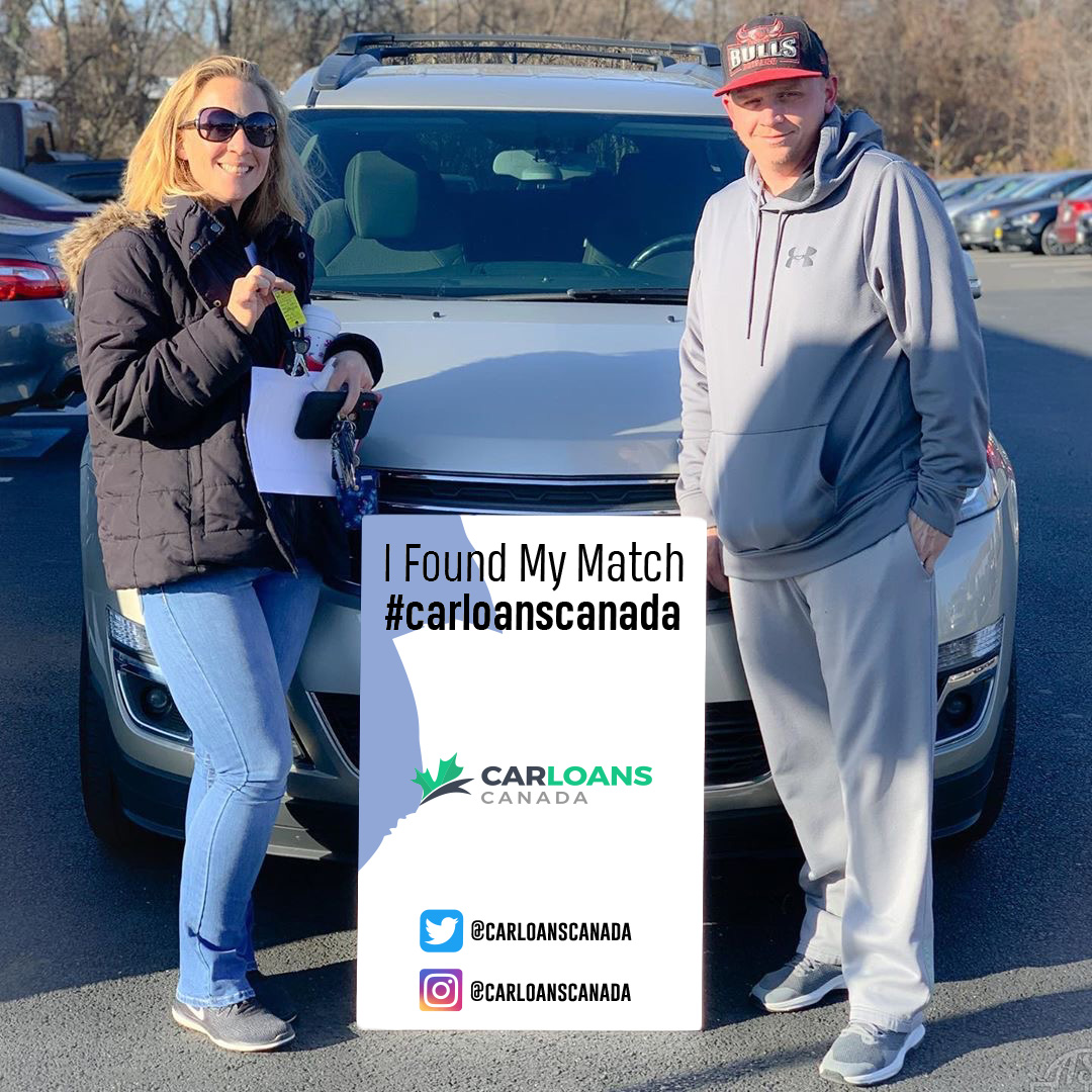Couple standing in front of car from car loans canada