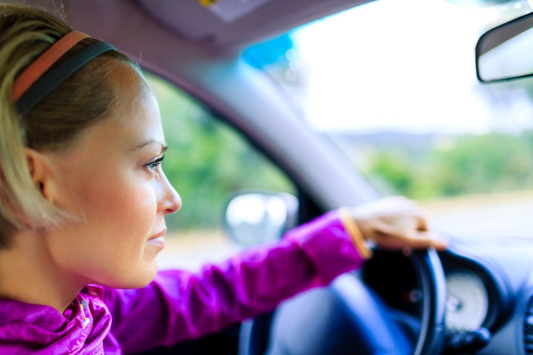 blonde woman driving her car